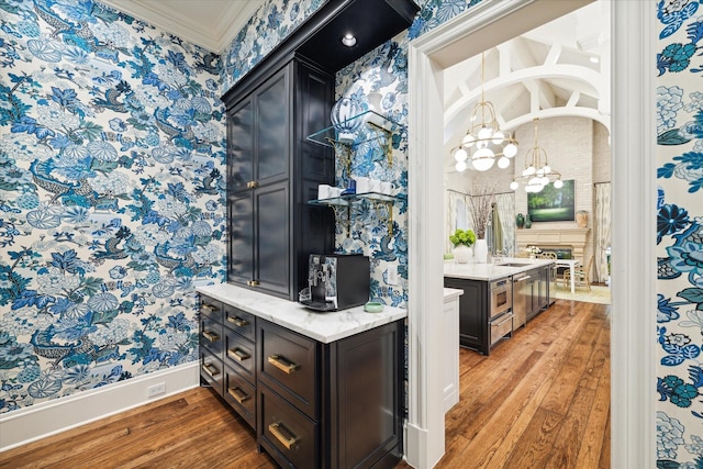 bar featuring wallpapered walls, ornamental molding, and wood finished floors