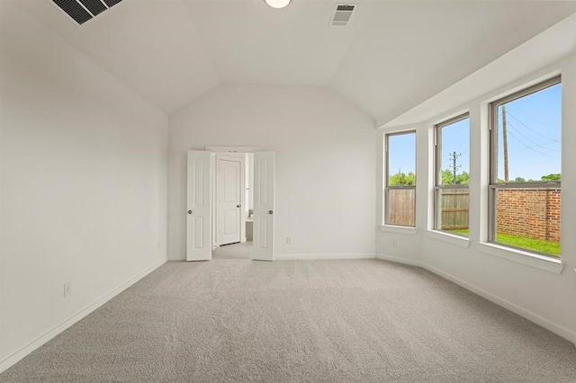 4918 Shore Arbor Ln, Katy, TX 77493 - empty room featuring light carpet, baseboards, and vaulted ceiling