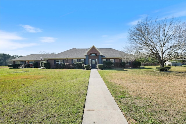 view of front of home featuring a front yard and brick siding