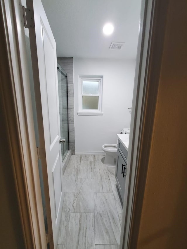 bathroom with toilet, visible vents, vanity, marble finish floor, and a shower stall