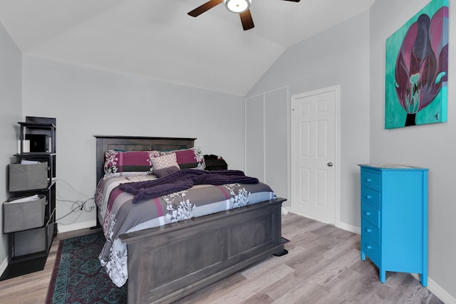 bedroom featuring vaulted ceiling, wood finished floors, baseboards, and ceiling fan