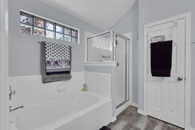 full bath featuring a garden tub, wood finished floors, and a stall shower