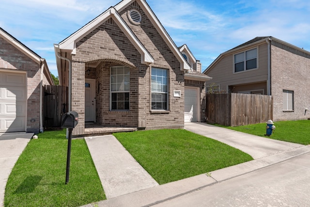 view of front of home featuring brick siding, driveway, a front lawn, and fence