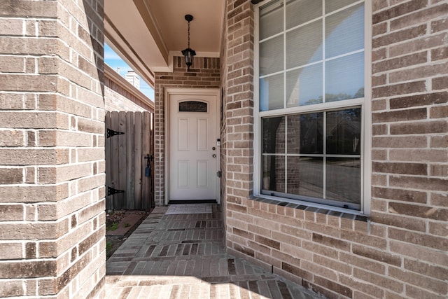 property entrance featuring brick siding