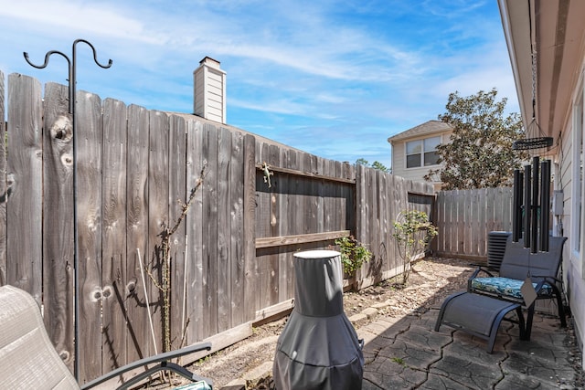 view of patio / terrace with cooling unit and a fenced backyard