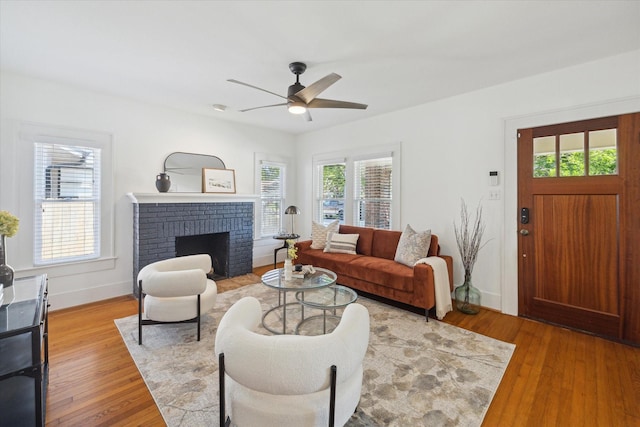 living room with a healthy amount of sunlight, a ceiling fan, and wood finished floors