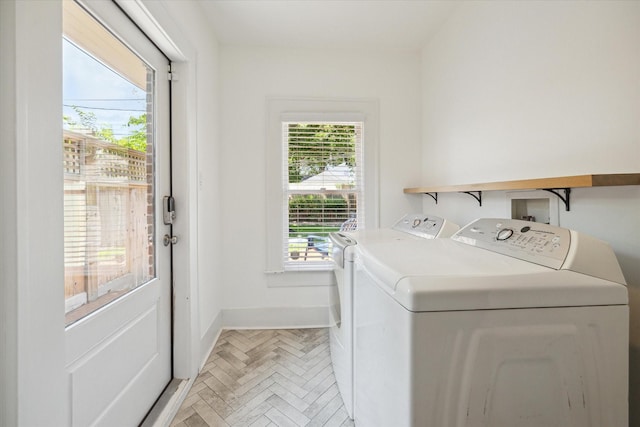 washroom featuring laundry area, independent washer and dryer, and baseboards