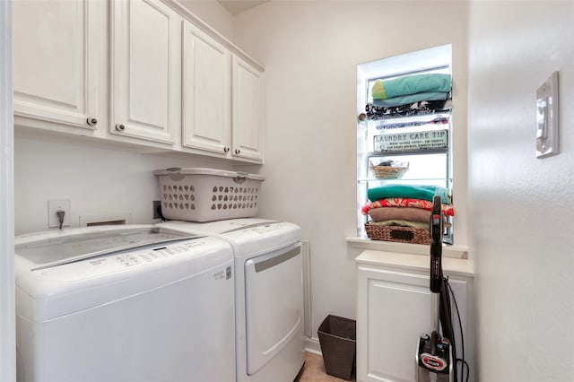 clothes washing area featuring cabinet space and washing machine and dryer