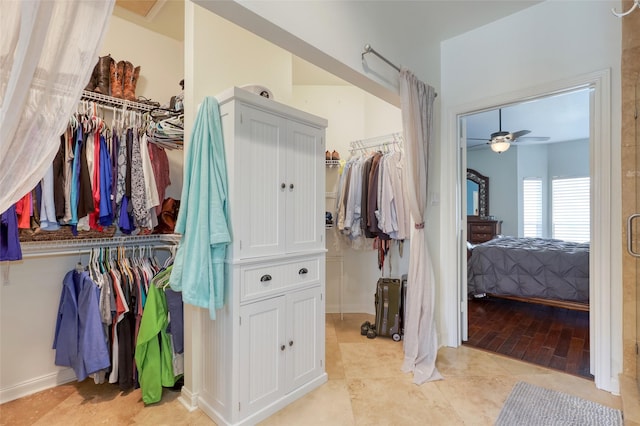 walk in closet with ceiling fan and light tile patterned flooring