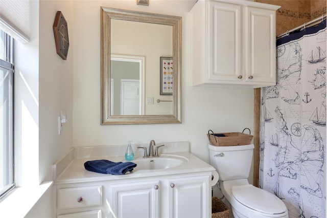 full bath featuring toilet, a shower with shower curtain, and vanity