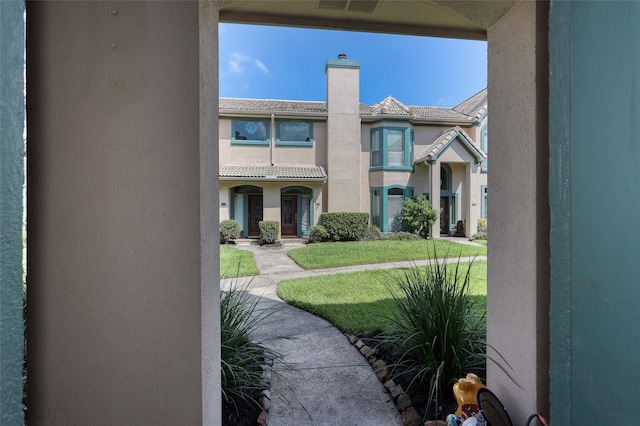 view of home's community with a lawn