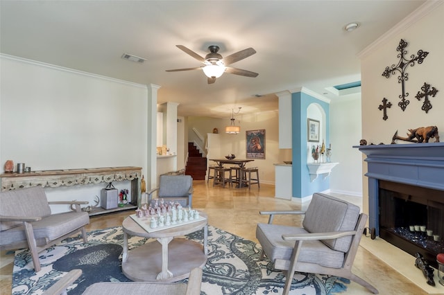 living area with a fireplace, visible vents, stairway, ornamental molding, and ceiling fan