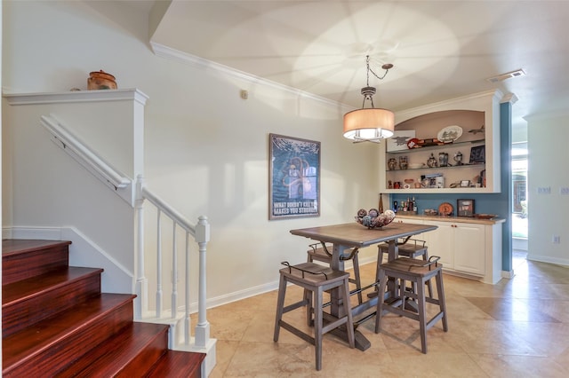 dining room with baseboards, stairs, visible vents, and ornamental molding