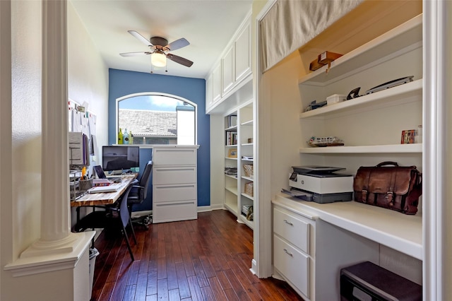 home office featuring dark wood-style floors, ceiling fan, and decorative columns