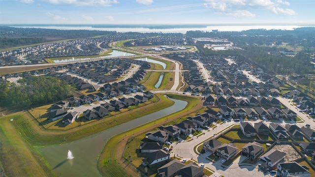 drone / aerial view featuring a water view and a residential view