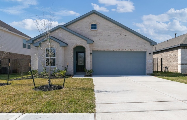 view of front of property featuring a garage, driveway, brick siding, and a front lawn