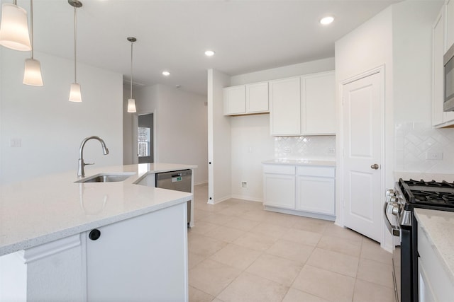 kitchen featuring pendant lighting, stainless steel dishwasher, gas stove, white cabinetry, and a sink