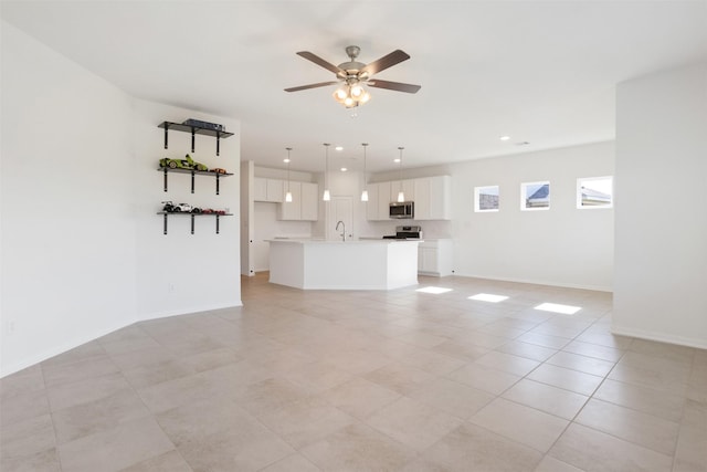 unfurnished living room with light tile patterned floors, recessed lighting, a sink, a ceiling fan, and baseboards