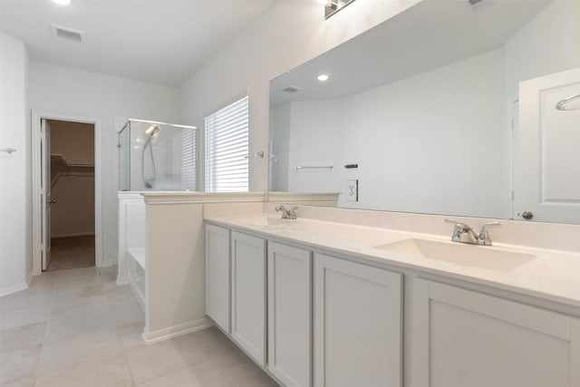 full bath featuring double vanity, an enclosed shower, visible vents, and a sink