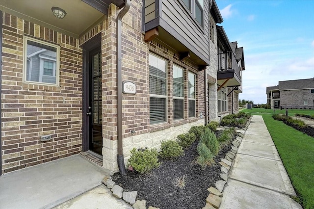 view of home's exterior with brick siding