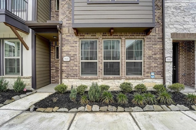 property entrance with brick siding