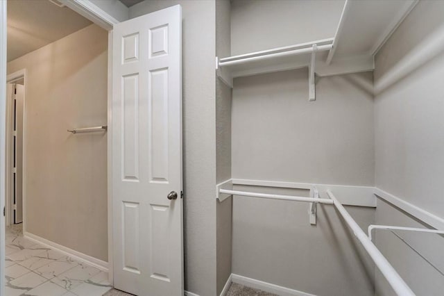 spacious closet featuring marble finish floor