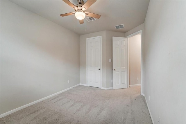 unfurnished bedroom featuring visible vents, carpet flooring, baseboards, and a ceiling fan