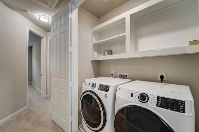 laundry area featuring baseboards, laundry area, light colored carpet, and separate washer and dryer