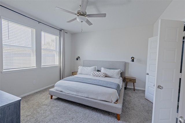 carpeted bedroom featuring ceiling fan and baseboards