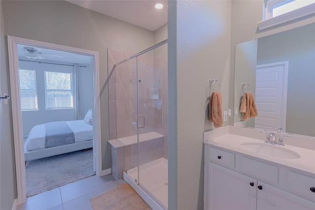 ensuite bathroom featuring tile patterned flooring, a wealth of natural light, and a shower stall