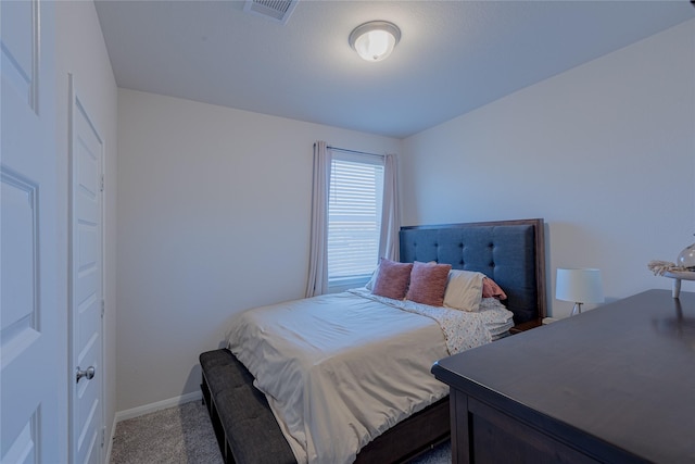 bedroom with carpet floors, visible vents, and baseboards