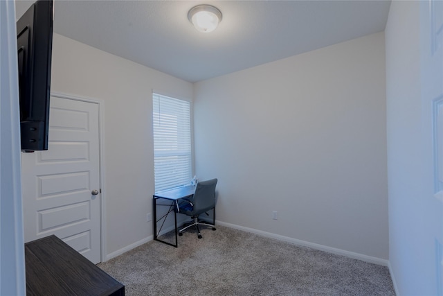 unfurnished office featuring carpet and baseboards