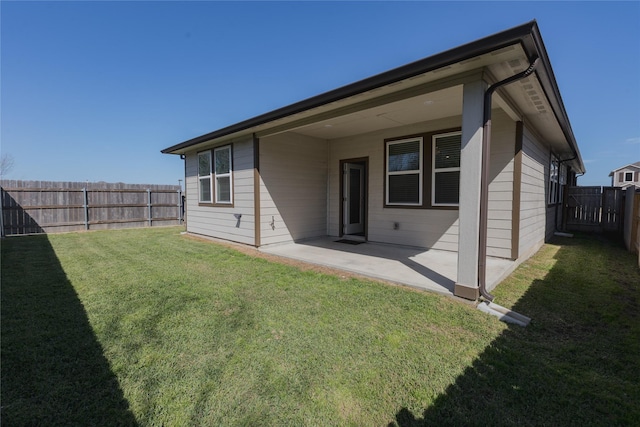 back of property featuring a patio area, a fenced backyard, and a lawn