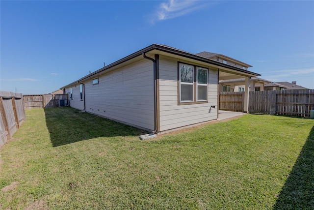 view of home's exterior featuring a fenced backyard, cooling unit, and a yard