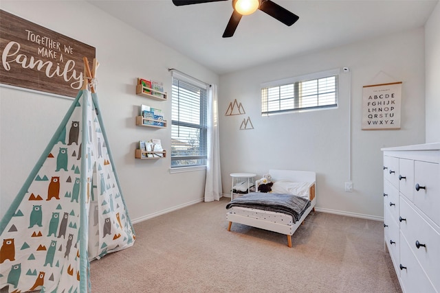 carpeted bedroom featuring a ceiling fan and baseboards