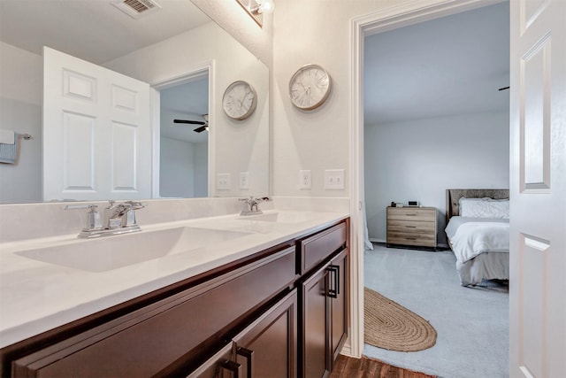 bathroom featuring visible vents, a sink, ensuite bath, and double vanity