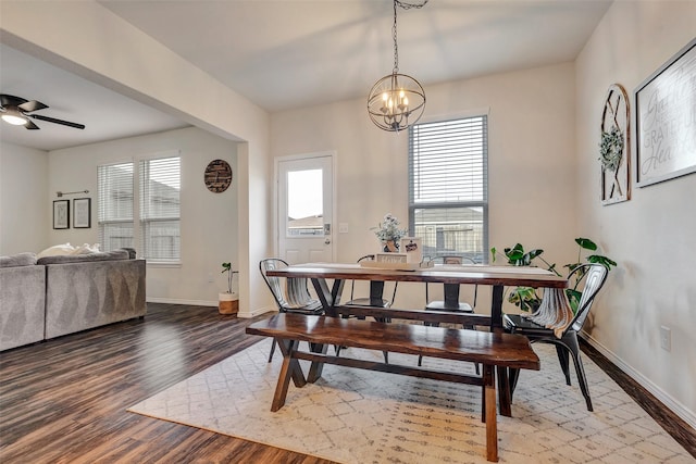 dining room featuring a healthy amount of sunlight, baseboards, and wood finished floors