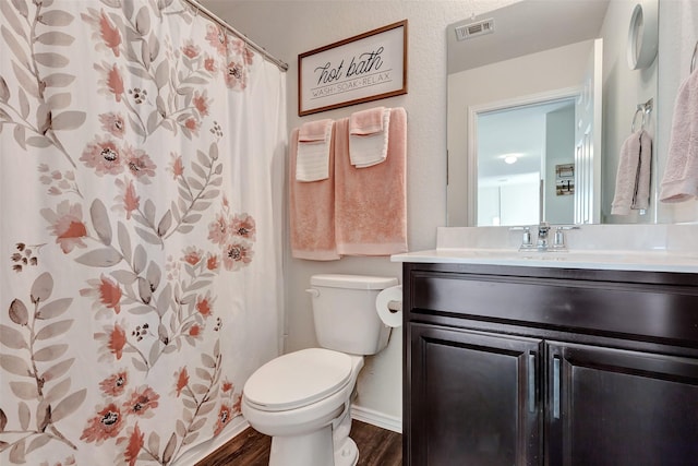 full bath featuring visible vents, toilet, a shower with curtain, wood finished floors, and vanity