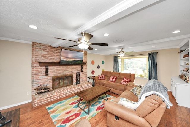 living room featuring crown molding, a textured ceiling, and wood finished floors