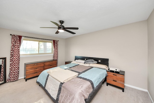 bedroom with baseboards, ceiling fan, and light colored carpet