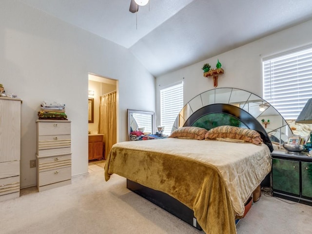 bedroom with lofted ceiling, multiple windows, a ceiling fan, and light colored carpet