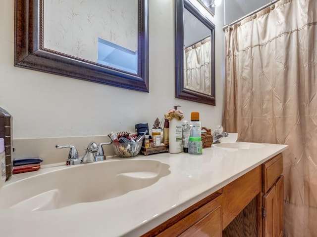 bathroom with a sink and double vanity