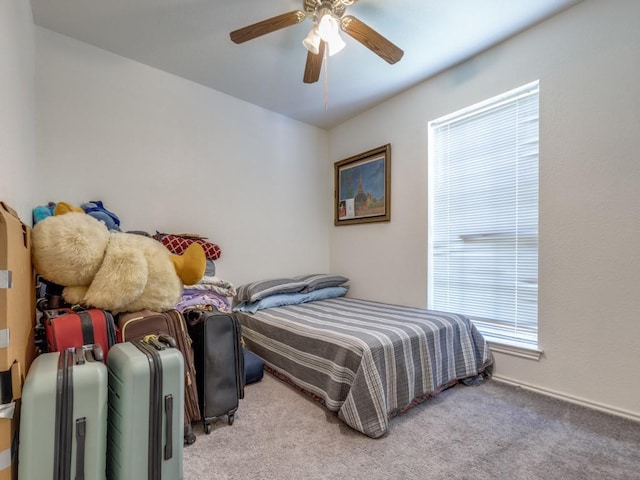 bedroom with a ceiling fan and carpet