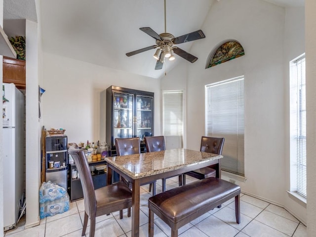 dining area with a ceiling fan, a wealth of natural light, and light tile patterned flooring