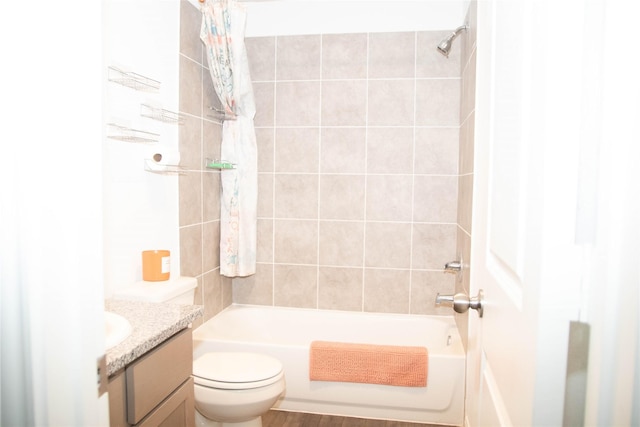 bathroom featuring toilet, shower / tub combo, and vanity