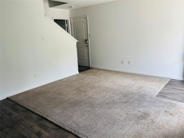 16955 Marie Village Dr, Conroe, TX 77306 - spare room featuring baseboards, carpet floors, and wood finished floors