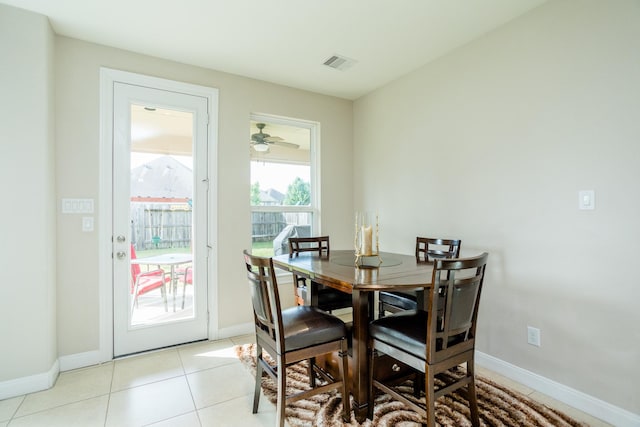 dining space with light tile patterned flooring, visible vents, and baseboards