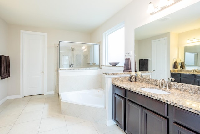 bathroom with a garden tub, vanity, baseboards, tile patterned floors, and a stall shower