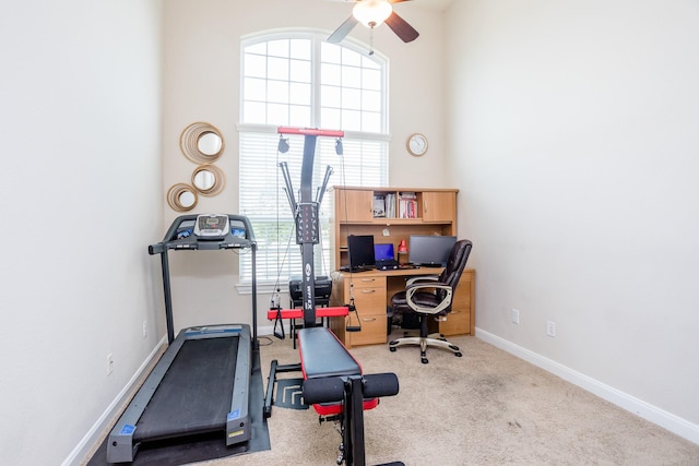 workout area featuring carpet, ceiling fan, and baseboards