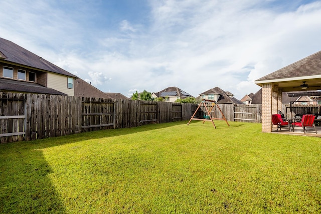 view of yard featuring a patio area, a fenced backyard, ceiling fan, and a playground